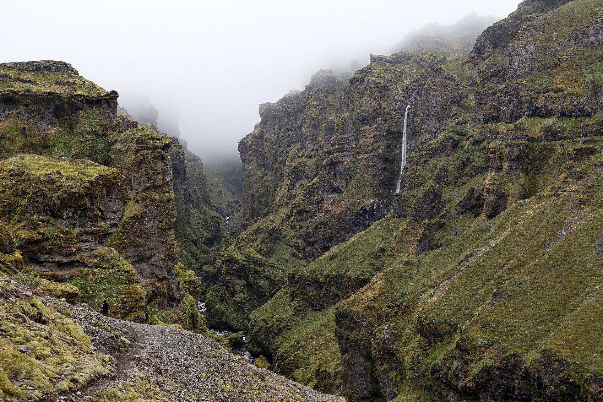 Wide view of the canyon in fog with Hangandifoss on the far wall